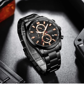 Close-up of black metal chronograph watch with date display and three subdials