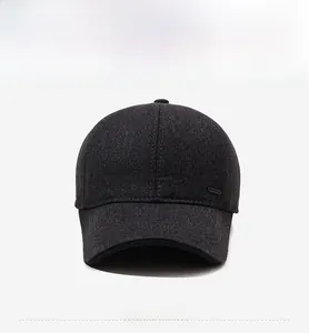 Close-up of thick grey wool baseball cap with sport metal logo and textured fabric detail