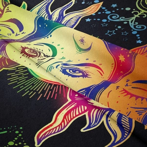 Detailed macro view showing soft fabric texture and colorful sun moon print on tapestry