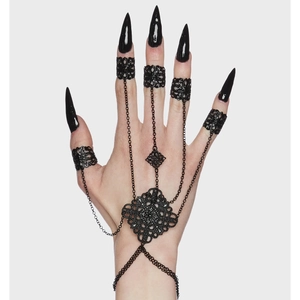 Gothic black filigree hand harness with five finger rings and spiked tassel details