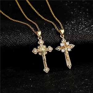Two elegant gold-plated cross necklaces with AAA cubic zirconia on black texture