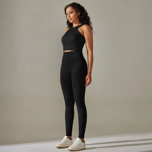 Detail of black seamless yoga set showing ribbed knit texture and athletic fit on model