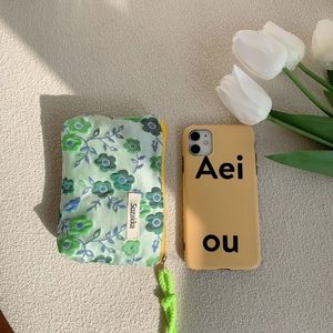 Floral fabric makeup pouch with mint green floral pattern and yellow phone case set