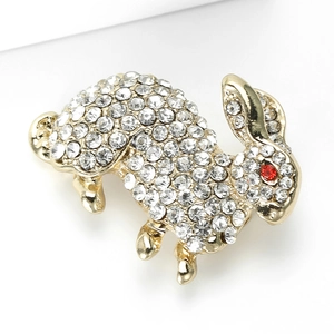 Detailed view of rabbit brooch with sparkling clear crystals and red rhinestone eye