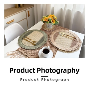 Detail of woven table mat set with fringe tassels and natural jute texture on a white table