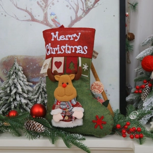 Detail of red Christmas stocking with 3D reindeer doll and Merry Christmas embroidery