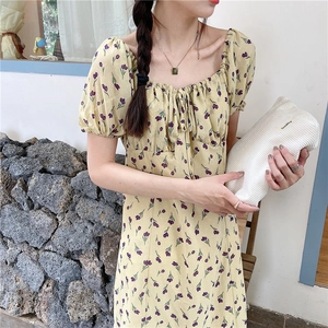 Detail of light yellow corduroy floral dress with puff sleeves and drawstring neck