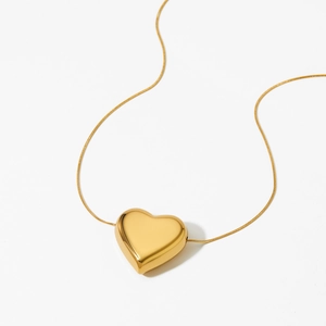 Polished gold hollow heart pendant necklace with sleek snake chain on white background