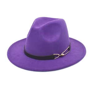 Close-up of purple wool fedora hat with black leather strap and gold metal buckle detail