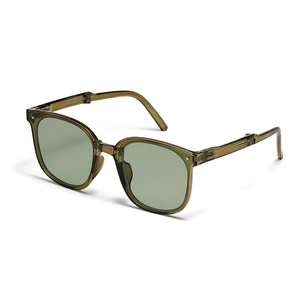 Detail of vintage green folding sunglasses showing the hinge mechanism and resin frame