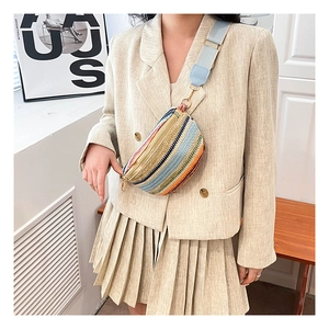Detail of bohemian colorful woven belt bag with adjustable strap and golden zipper