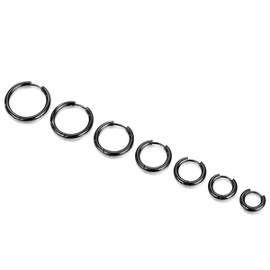 Minimalist black stainless steel hoop earrings set in seven different sizes on white
