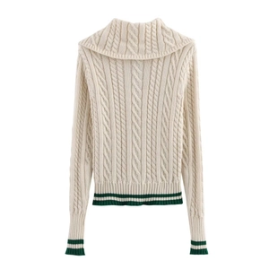 Women's cream knit sweater with green stripes and cable-knit texture on white background