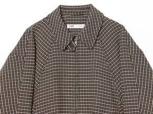Detail of classic houndstooth jacket neckline with metal zipper and texture close-up