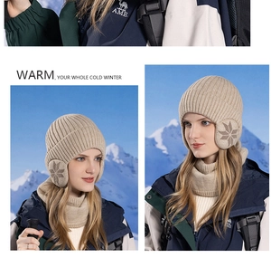 Detail of warm beige winter knit hat and neck warmer set with snowflake pattern