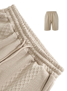 Detail of men's beige waffle knit shorts with elastic waistband and drawstring