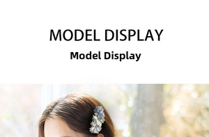Detail view of handmade fabric flower hair clip in light blue and green tones
