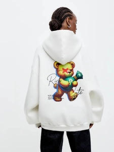 White oversized hoodie featuring a stylish cartoon bear print and street fashion graphics