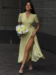Detail of high-slit floral wrap maxi dress with V-neck and tie waist for summer fashion