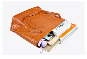 Internal view of large brown crocodile pattern tote bag showing high capacity for laptops
