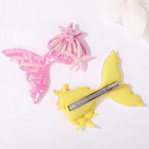 Set of pink sequined and yellow fabric mermaid tail hair clips for girls shown on white background