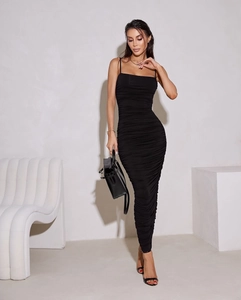 Detail shot of the ruched texture and slim fit design on this black maxi dress