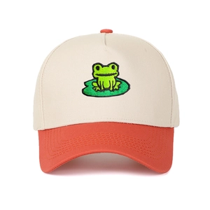 Detailed close-up of cartoon frog embroidery on a two-tone cotton trucker baseball cap