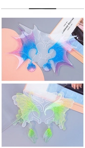 Detailed macro view of gradient resin elf ear cuffs with butterfly wings and shell charms