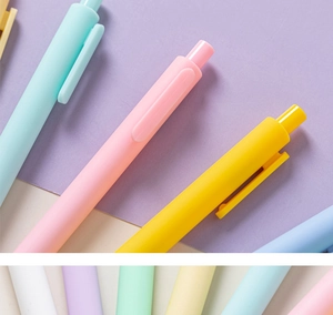 Close-up of pastel macaron colored retractable gel pens with matte finish texture