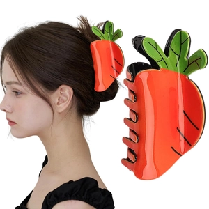 Detail of vibrant orange carrot hair claw clip shown on model for hair styling
