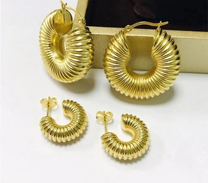 Gold stainless steel ribbed hoop earrings and stud set, stylish fashion jewelry for women.