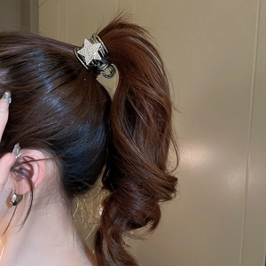 Macro detail of silver star hair claw clip with rhinestones for high ponytail