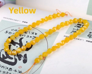 Macro view of faceted yellow natural stone beads with a polished diamond-cut surface
