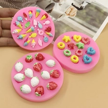 Detail of pink silicone molds creating miniature ice cream, donuts and strawberry shapes