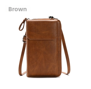 Detail view of brown lychee grain leather crossbody phone bag with front flap pocket