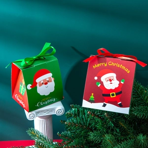 Christmas gift boxes in red and green with Santa Claus illustrations and silk ribbons
