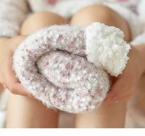 Close-up of thick pink and white striped coral fleece floor socks with plush texture