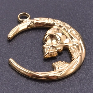 Detailed view of a gold-plated stainless steel crescent moon with a skull profile design