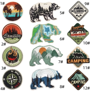 Detail view of 12 assorted colorful outdoor camping and adventure embroidered patches