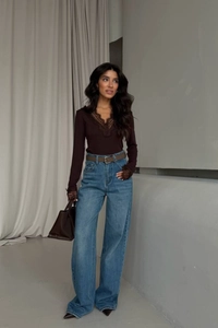 Lace-up V-neck long sleeve top in dark brown paired with wide-leg blue denim jeans