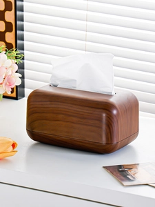 Close-up of walnut wood grain texture on a minimalist rectangular tissue box holder