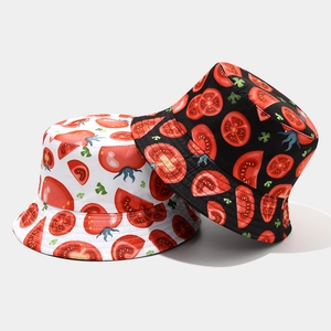 Detail of tomato print reversible sun hats in black and white canvas fabric