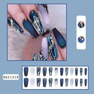 Detail of blue marble matte press-on nails with gold foil and handcrafted rhinestones