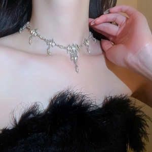 Close-up of silver crystal choker with teardrop pendants on model neck for styling