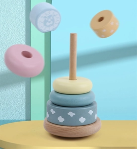 Close-up of wooden rainbow tower rings with animal prints in macaron colors