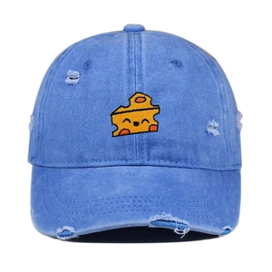 Close-up of blue washed denim baseball cap with distressed holes and cheese embroidery