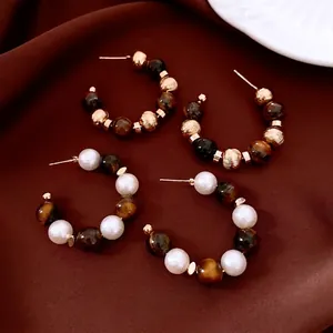 Vintage 16K gold plated tiger eye bead C-shape earrings with pearls on silk background
