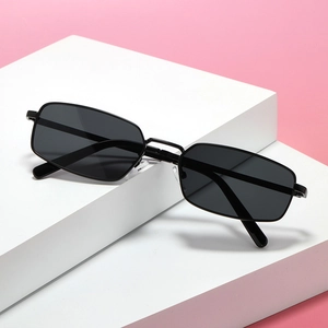 Retro rectangle metal sunglasses with black frames displayed on a modern pink background