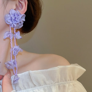 Detail of purple chiffon flower tassel earrings featuring layered petals and beaded drops