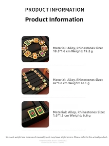 Detail of vintage jewelry set with red and green rhinestones on black leather trays